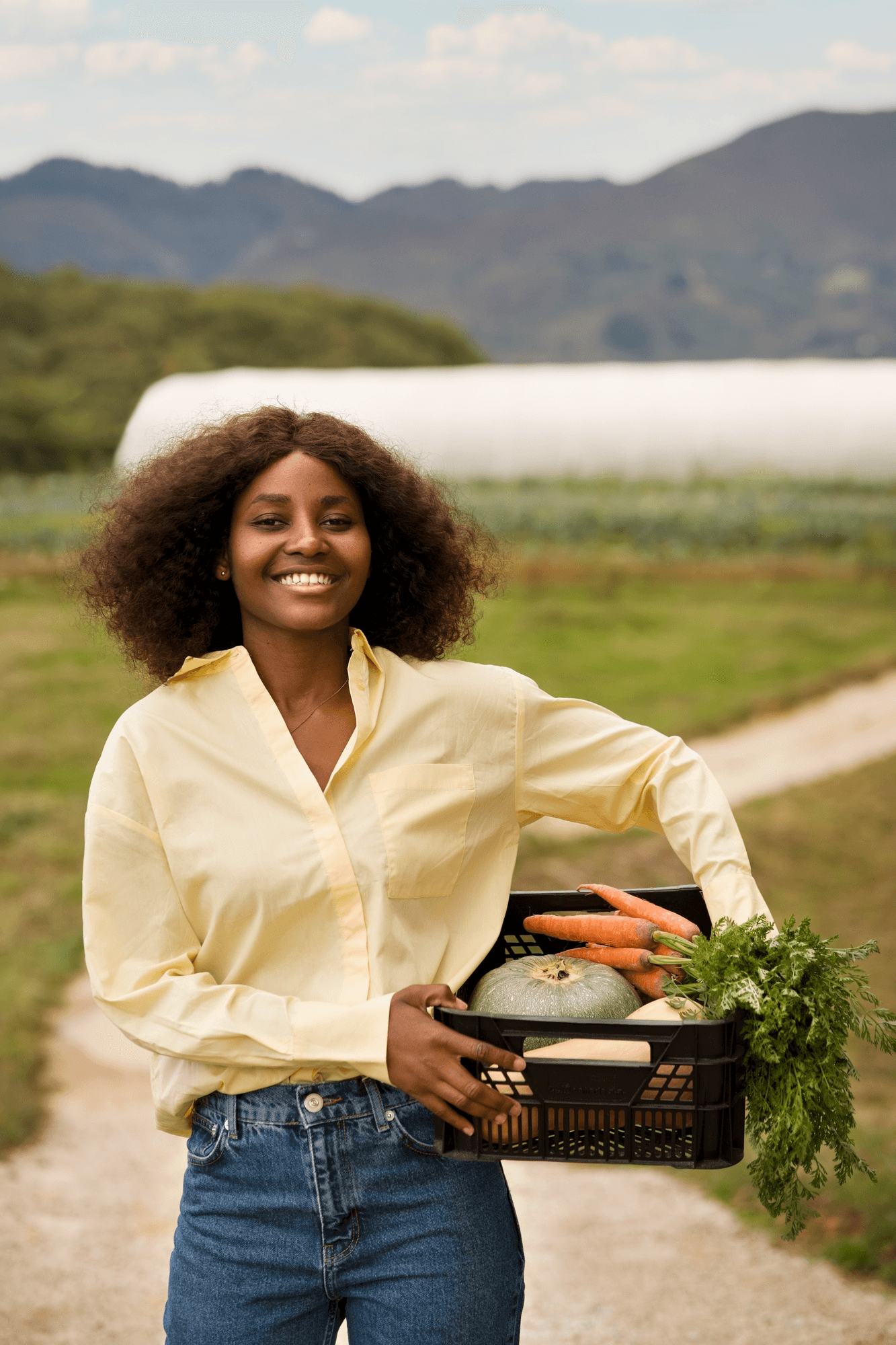 A farmer holding a basket of freshly harvested produce